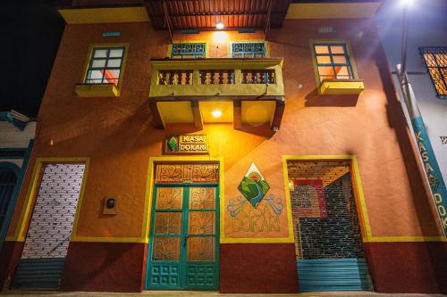 a building with colorful doors and windows on it at Hotel Kasa Dokari in Honda