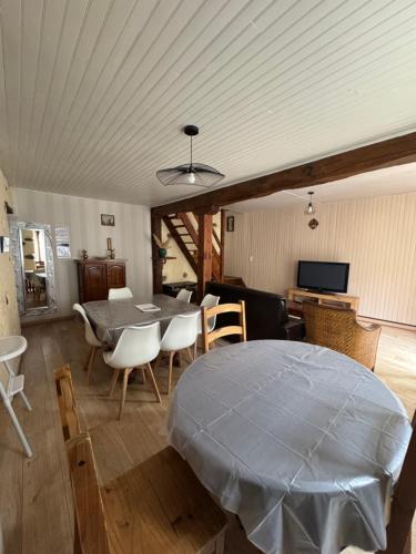 a bedroom with a bed and a table and chairs at Aucairn in Château-Verdun