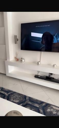 a flat screen tv sitting on a white shelf at Luxury villa in Entebbe