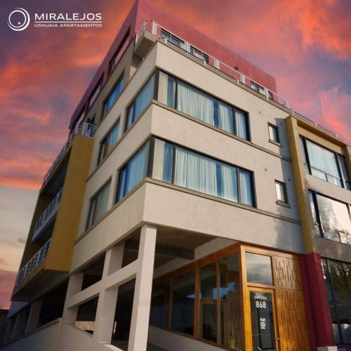 a tall building with a sunset in the background at Miralejos in Ushuaia