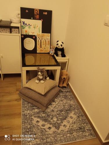 a room with a chair and stuffed animals on a rug at Kuća za odmor Donja Grabovica in Valjevo