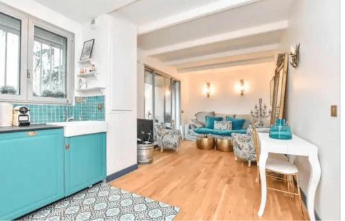 une cuisine avec des placards bleus et un canapé bleu dans l'établissement Place du Trocadero 25 mins away, à Boulogne-Billancourt