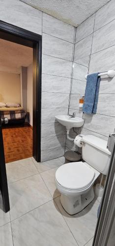 a bathroom with a toilet and a sink at Departamento Tulcán in Tulcán