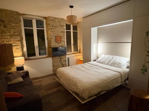une chambre avec un lit et un canapé dans l'établissement Appartement avec terrasse à Hôtel de Ville, à Vannes