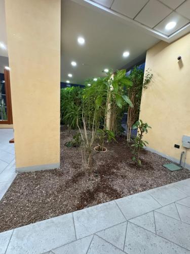 a lobby with trees and plants in a building at Torre Sole Fiumara in Genova