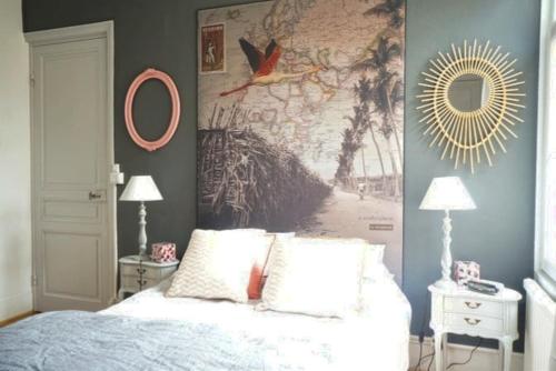 a bedroom with a bed and a large painting on the wall at Malo Les Bains House & Beach Garden 5 min walk in Malo-les-Bains