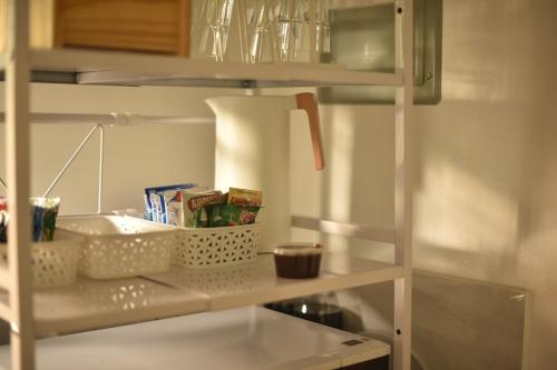 a white shelf with some food on it in a kitchen at The Zentuary - House with pool in Amadeo