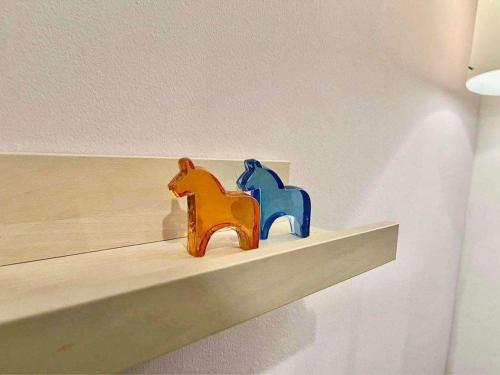two figurines of two horses sitting on a shelf at Wowstaycation in Manila