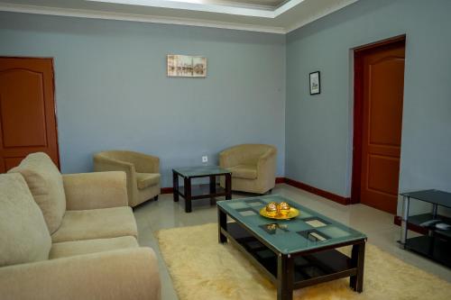 a living room with a couch and a coffee table at Downtown Oasis Suites in Lilongwe