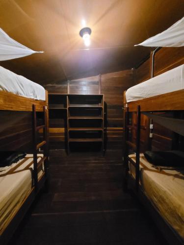 a room with three bunk beds and a light at Mano Verde Minca in Minca