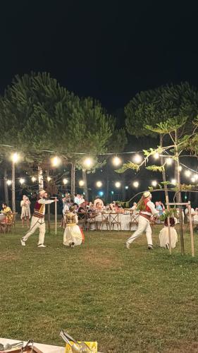 a group of people dancing in a park at night at Dreamscape at San Pietro Premium - next to Meliá in Lalzit Bay