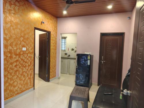 a hallway with a door and a chair in a room at KOTLAS Highliving Service Apartments in Gachibowli