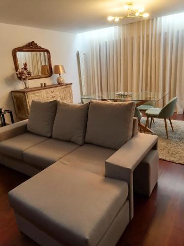 a living room with a couch and a table at Apartamento Centro Guimarães com Vista Panorâmica in Creixomil