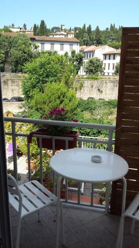 a white table and two chairs on a balcony at Lodges le Mura 2 in Florence
