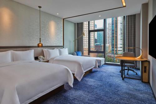 a hotel room with two beds and a large window at The St. Regis Chicago in Chicago