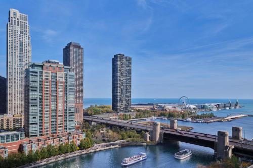 a city with a bridge and boats in the water at The St. Regis Chicago in Chicago