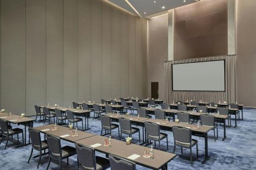 a conference room with tables and chairs and a screen at The St. Regis Chicago in Chicago