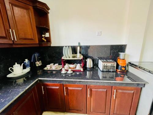 a kitchen with wooden cabinets and a counter top at Warusha Villa in Hikkaduwa