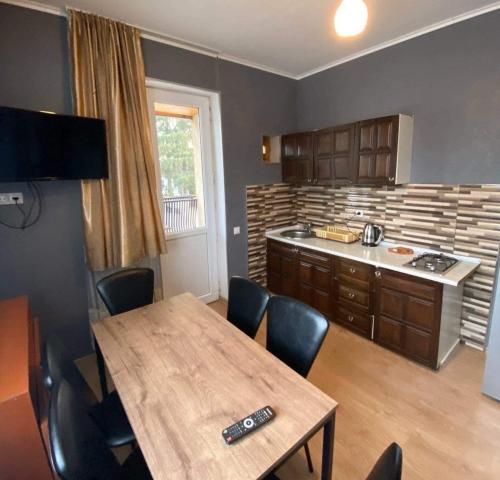 a kitchen with a wooden table and a dining room at Home in Bakuriani in Bakuriani