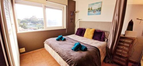 a bedroom with a bed with two stuffed animals on it at Studio on Maria Luisa Beach Wifi Parking Swimming Pool in Olhos de Água