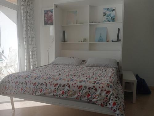 a bedroom with a bed with a comforter on it at Castillo Santa Clara in Torremolinos
