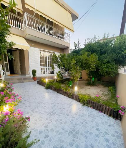 a courtyard of a house with flowers and lights at Katsaras House 3 Cozy Bedrooms in Kremasti
