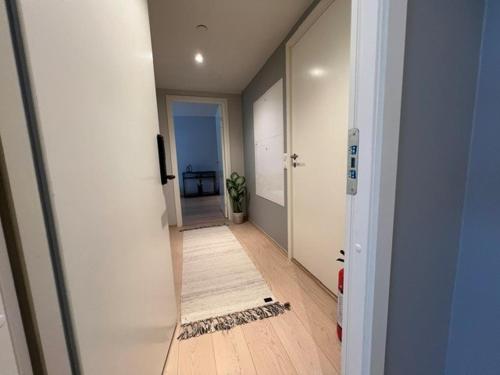 an empty hallway with a mirror in a room at Fantastic apartment on prime location in Oslo