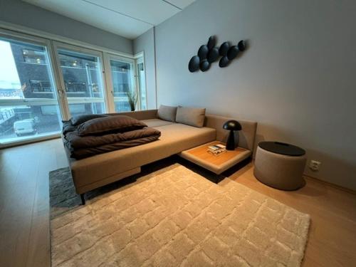 a living room with a couch and a table at Fantastic apartment on prime location in Oslo