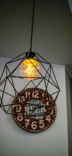 aendant light with a sign hanging from a ceiling at ONRest Hostel Centrum Żytnia 8 FaktVat in Kielce