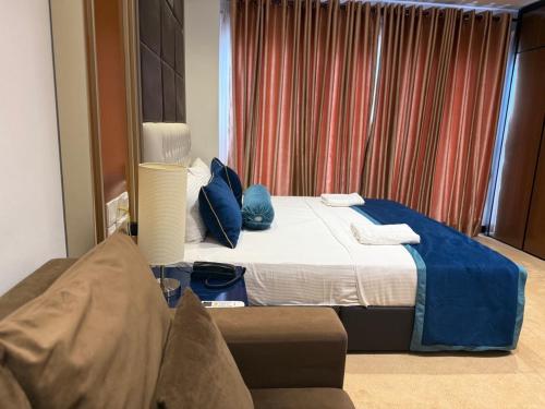 a hotel room with a bed and a couch at Negombo Ocean Breeze - ShoresEdge Luxury Apartments in Negombo