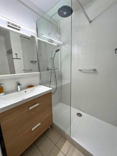 une salle de bain avec douche et lavabo dans l'établissement Cigales de la Mer - climatisé, vue mer et parking, au Grau-du-Roi