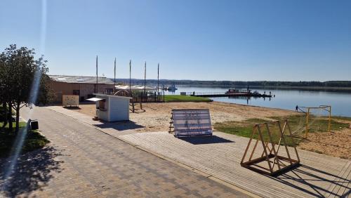 a boardwalk with a playground and a dock on a lake at Apartment vanalinnas in Võru
