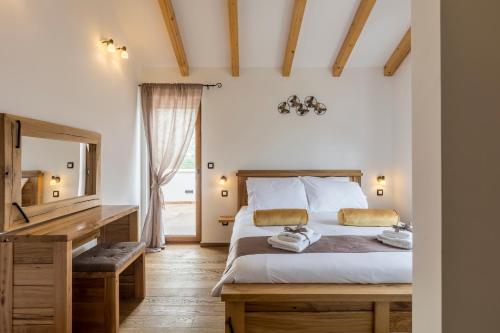 a bedroom with a bed with a desk and a mirror at Villa Grey Stone in Gata