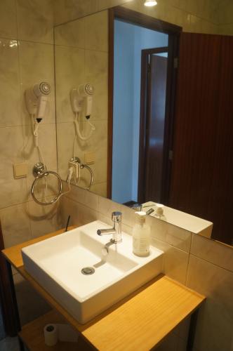 a bathroom with a sink and a mirror at Casa no centro histórico in Vila Nova de Gaia