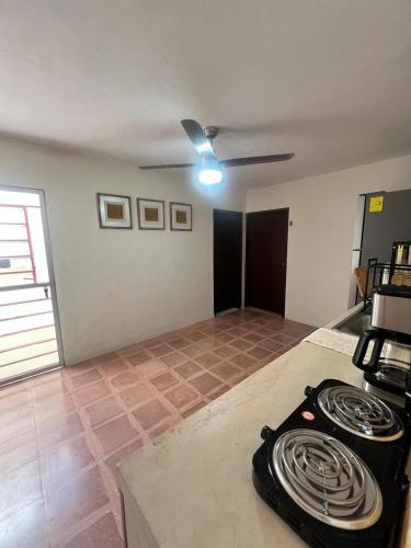 a kitchen with a stove top in a room at Casa en el Centro de Mérida, 5 habitaciones y 3 baños, ideal para grupos in Mérida