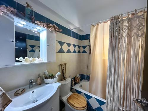 a bathroom with a sink and a toilet and a shower at Katsaras House 3 Cozy Bedrooms in Kremasti