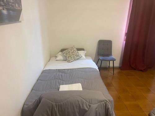 a small bedroom with a bed and a chair at Good Morning Venice in Venice
