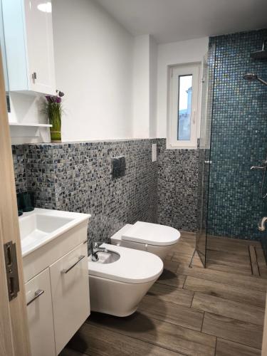 a bathroom with a toilet and a sink and a shower at Victoria Elegance Apartment in Sofia