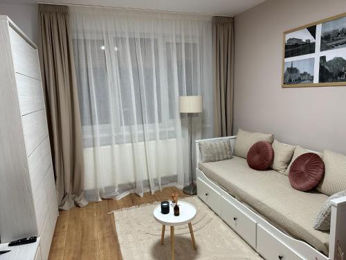 a living room with a couch and a table at Apartament Cetate Deva in Deva