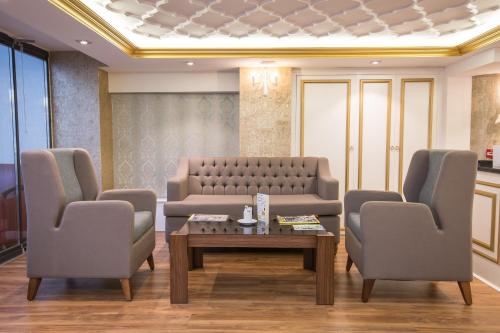 a waiting room with a couch and two chairs and a table at Ruba Palace Thermal Hotel in Bursa