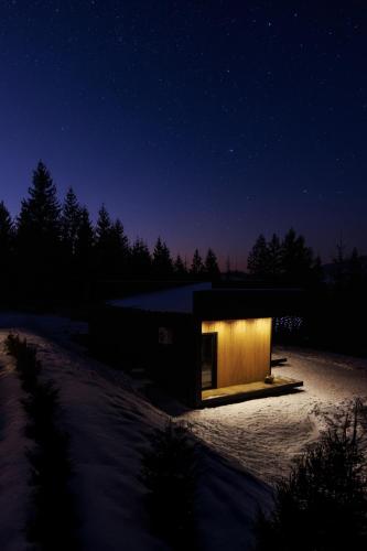 a small building in the snow at night at Carpathians View in Krivopolʼye
