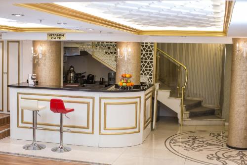 a lobby with a bar and a red stool at Ruba Palace Thermal Hotel in Bursa