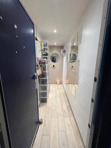 un couloir avec une porte menant à une chambre dans l'établissement Appartement le menilmontant, à Paris