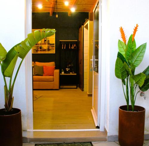 a hallway with two potted plants and a couch at Katoi suite in Éxo Khóra