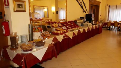 a long line of tables with food on them at Park Hotel Miramonti in Folgaria