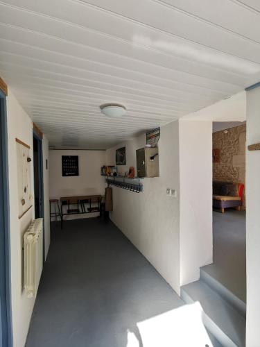 une pièce vide avec une cuisine et une table dans l'établissement Ancienne maison de pêcheur pour un séjour reposant, à LʼAiguillon-sur-Mer