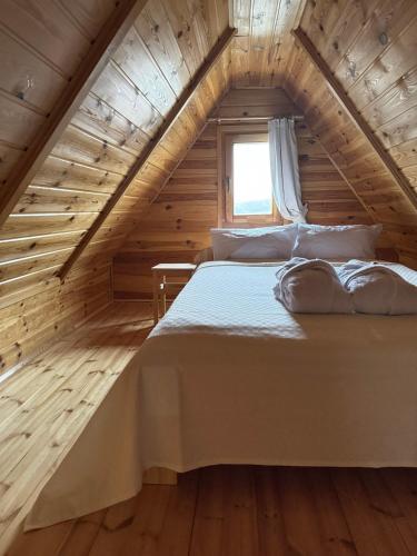 a bedroom with a bed in a wooden house at Villa Lena Nagymaros in Nagymaros