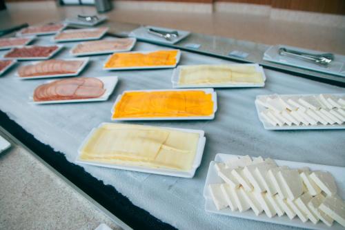 a table with different types of cheese and meats at Costeira Palace Beach Resort All Inclusive in Natal
