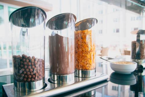 a counter with three food blenders filled with food at Costeira Palace Beach Resort All Inclusive in Natal