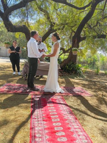 a bride and groom standing next to each other at A Little Guesthouse in Bloemfontein
